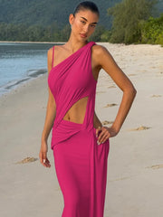 A woman modeling a one-shoulder pleated backless maxi dress.