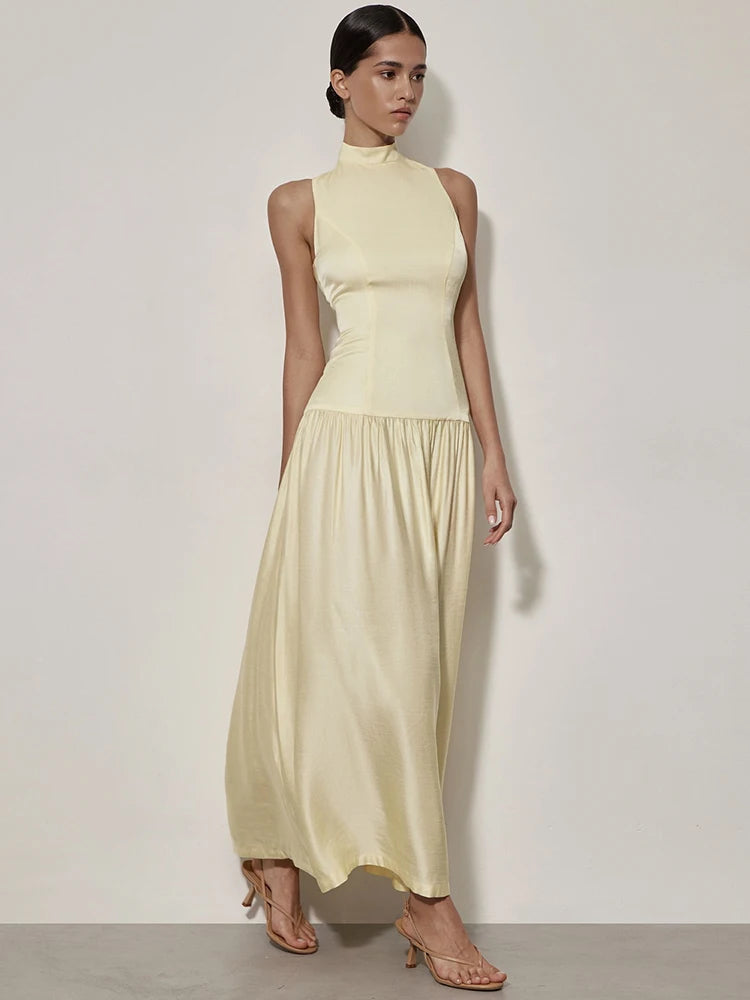 Woman wearing sleeveless round neck open back maxi dress