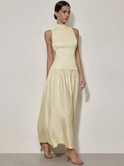 Woman wearing sleeveless round neck open back maxi dress