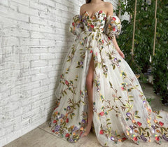 Woman wearing open shoulder embroidered mesh long gown