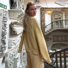 The back view of the cardigan, showing the open-stitch design.

