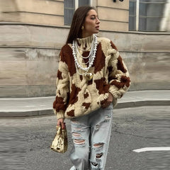 Oversized pullover in bold cow print with cozy knit texture
