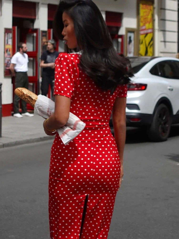 Parisian-inspired red polka dot dress styled for city strolls with baguette