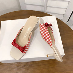 Party vacation sandal women’s style shown on a wooden table on a white box.