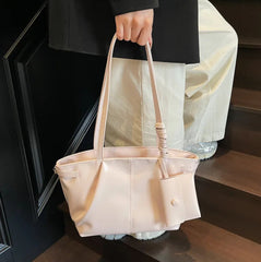 Oversized pink handbag with roomy interior and strap