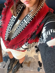 Close-up of the shawl collar and patterned knit detailing on a fringe-trim cardigan.