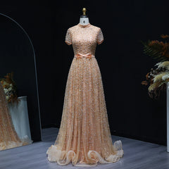 Beige evening gown on a mannequin against a dark background