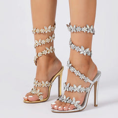 A close-up view of the peep toe and thin heel on the elegant high heels.