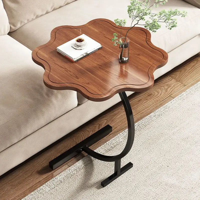 Petal-shaped wood top side table beside a neutral sofa