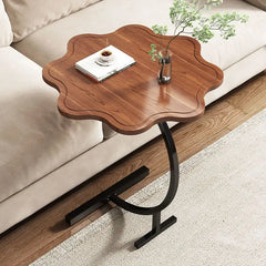 Petal-shaped wood top side table beside a neutral sofa