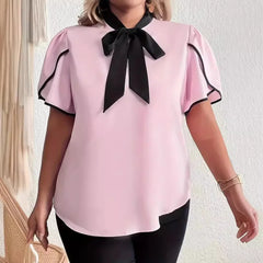 Pink bow black seam blouse styled with black pants for modern office looks