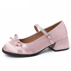 Elegant blush women’s dress shoes styled on soft fabric
