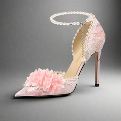 Pink embroidered floral pointed heel with pearl ankle strap styled for spring bridal party on a white background