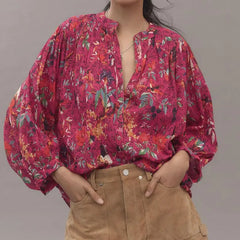 Close-up of pink printed button-down blouse with lantern sleeves