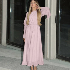 Woman wearing pink ruffled maxi dress with butterfly sleeves