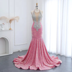 Sheer halter sequin mermaid prom gown with floor-length hem on mannequin