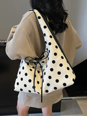 Playful retro shoulder purse with bow carried on the arm
