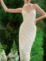 White event dress with an empire waist and sculpted drape
