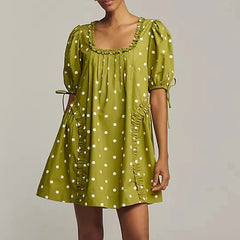 A close-up of the pleated frill and ruffle details on the dress.