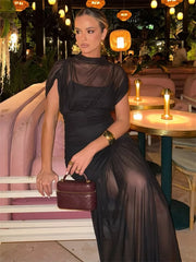 Close-up of sheer mesh detailing and natural waist on black maxi dress