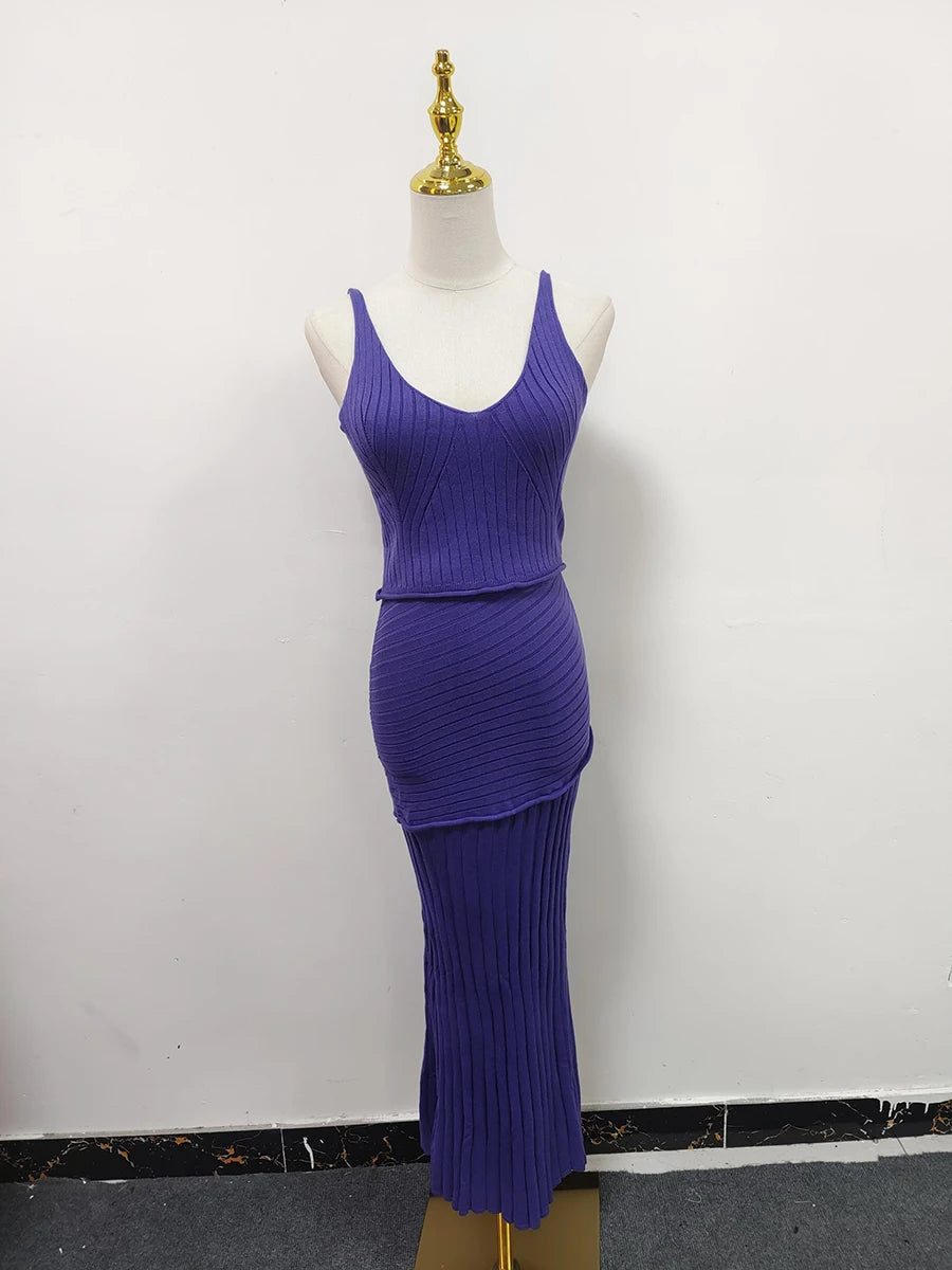 Purple ribbed dress on a mannequin against a white background