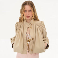 A woman wearing a pleated stand collar short jacket, styled for a casual outing.