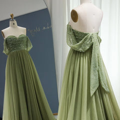 The pleated tulle evening dress is styled for a glamorous event.