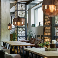Modern Nordic glass stone pendant light illuminating cozy dining area