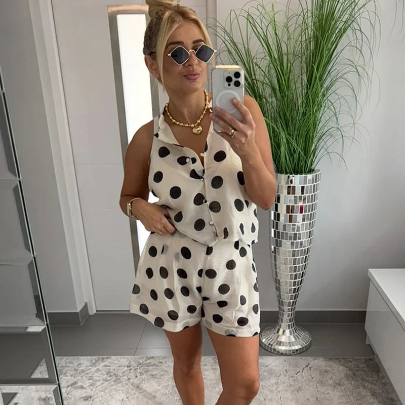 A woman wearing a polka dot halter-neck top and shorts set.