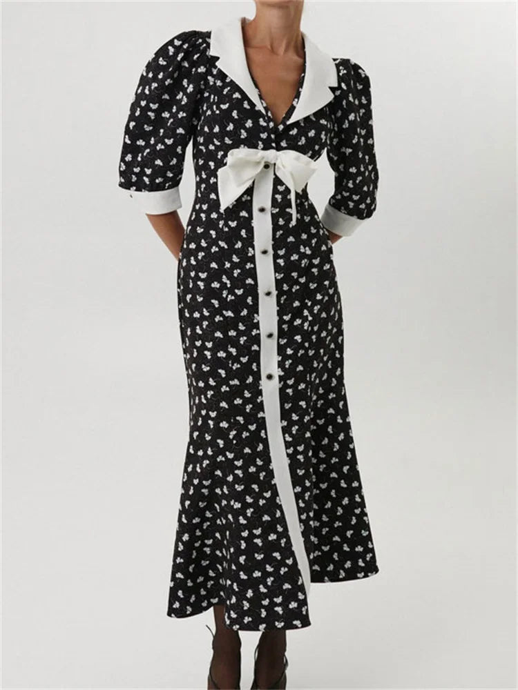 Polka dot  black maxi dress with white collar and bow, shown front view
