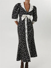 Polka dot  black maxi dress with white collar and bow, shown front view