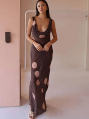 Woman wearing a brown dress with cut-out design in a minimal indoor setting