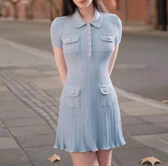 A woman wearing a blue polo collar knit mini dress with pockets with multiple pockets.