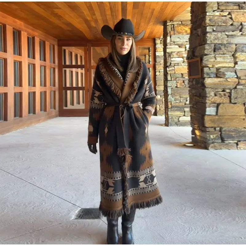 Front view highlighting the graphic border print and tassel hem on a brown cardigan coat, cinched neatly at the waist.