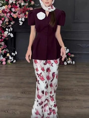 A close-up of the printed fabric and button detail on the top.