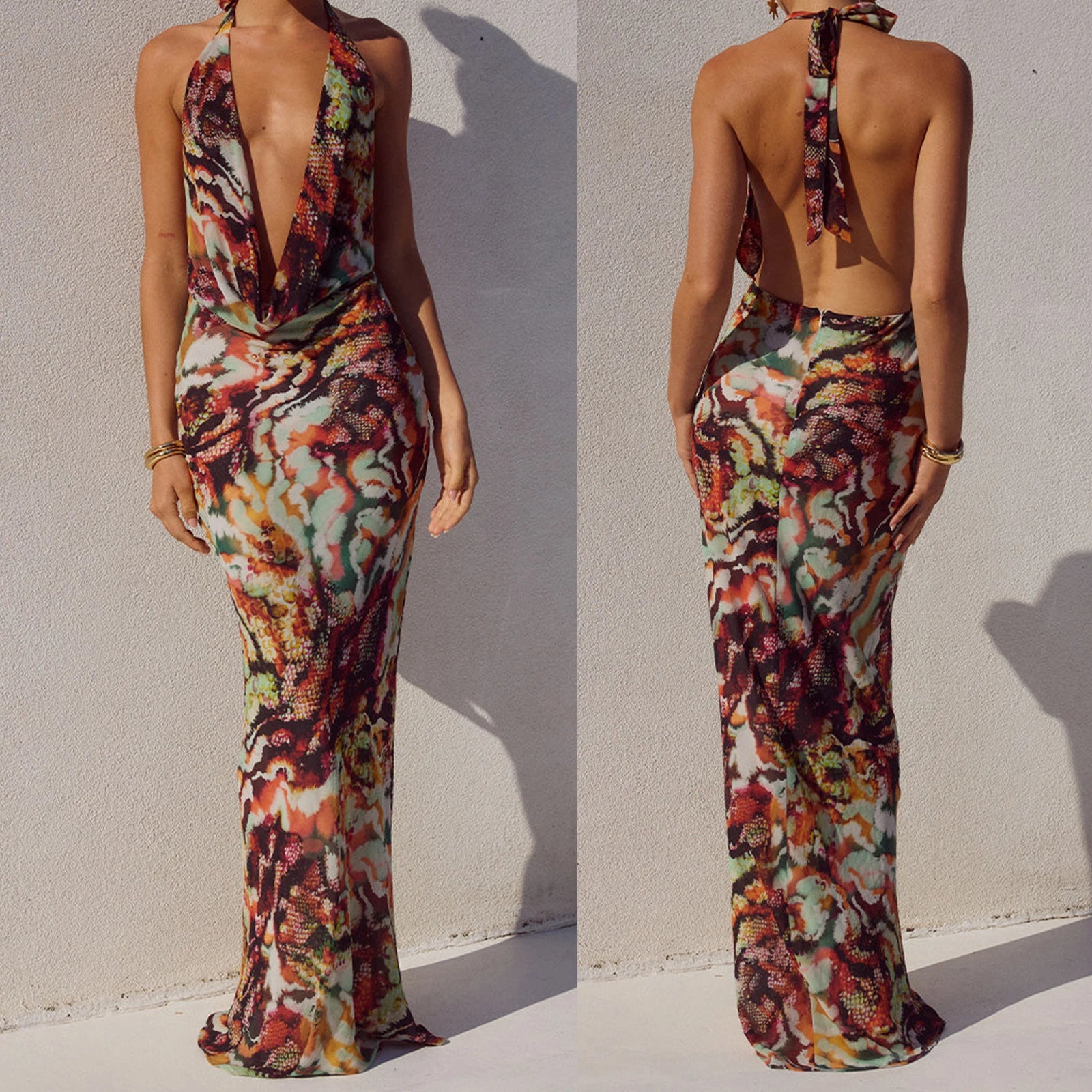 Multicoloured patterned long dress worn by a model against a white background
