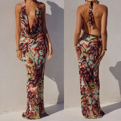 Multicoloured patterned long dress worn by a model against a white background