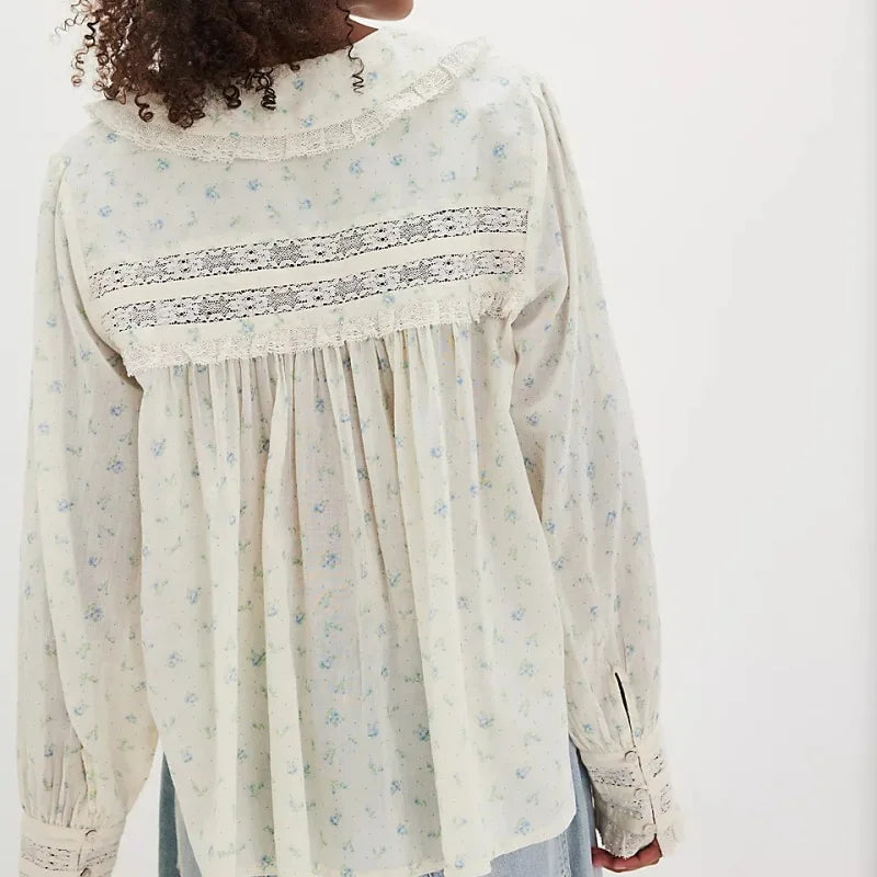 Detail view of the blouse sleeve and cuff highlighting the lightweight fabric and subtle print.