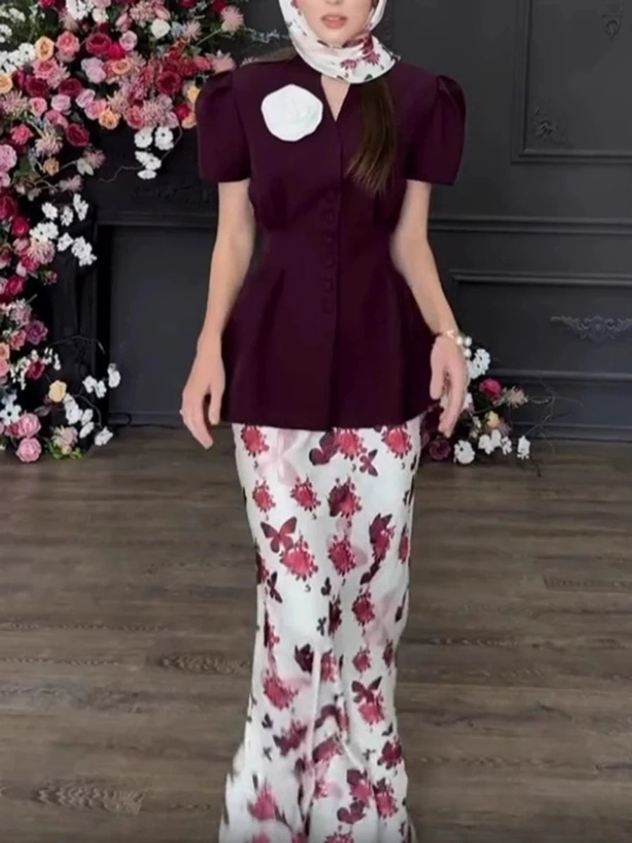 A woman modeling a printed two-piece set with a V-neck top and a maxi skirt.