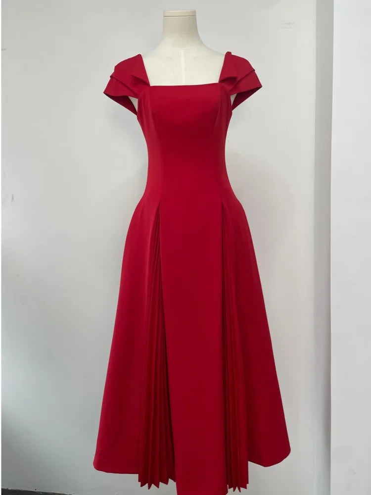 Close-up of the square neckline and puff sleeve detail on a midi dress