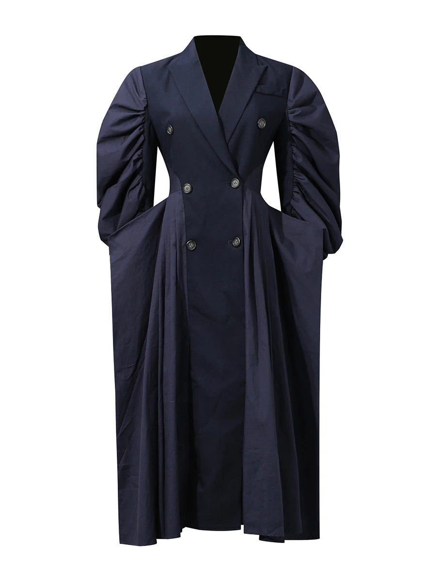 Trench-inspired blue midi dress with a sculpted feminine silhouette