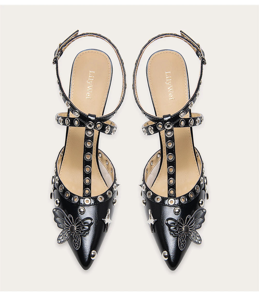 A woman modeling a punk rivet sandal with a butterfly and a thin heel.
