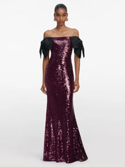 Lower-half detail of the purple sequin maxi dress showing the slim column line and hem pooling slightly on the floor.
