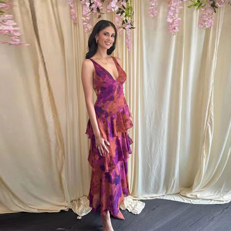 Woman wearing purple printed V-neck maxi dress with tiered ruffle skirt