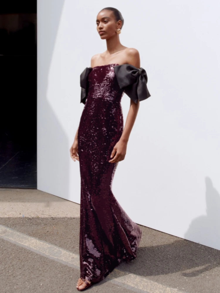 Close-up of dense purple sequins catching light across the bodice, showing a smooth, sculpted finish with fine sparkle texture.