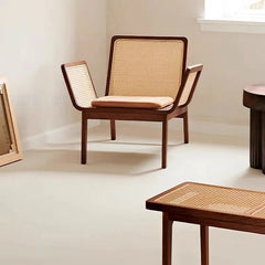 Natural rattan wicker chair with solid teak frame .