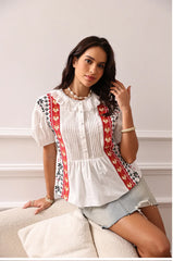 White blouse with red and black embroidery for folk-inspired looks