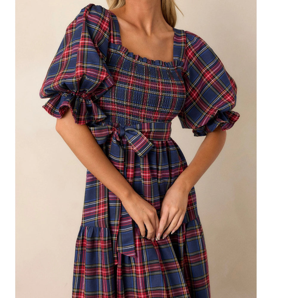 Side angle of A-line plaid dress showing flowy skirt