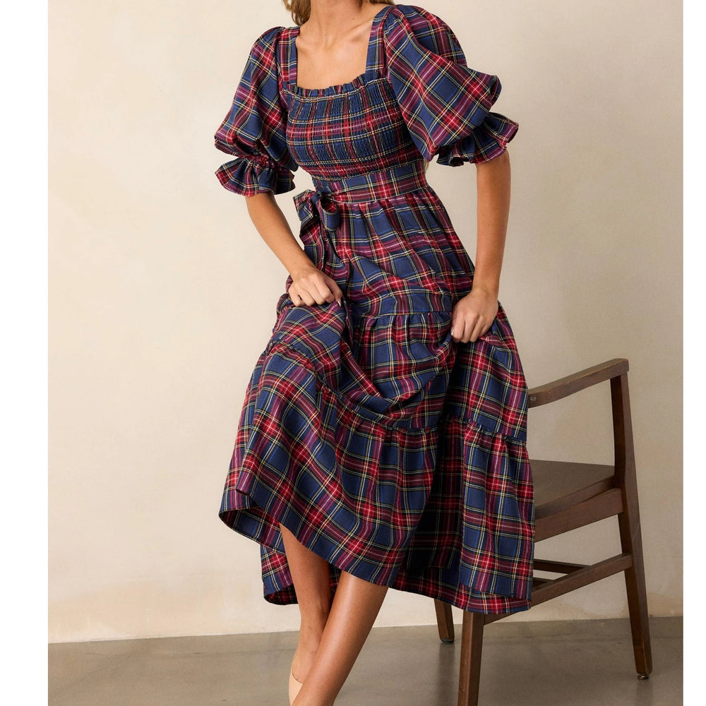 Woman wearing a red and blue plaid puff sleeve A-line midi dress
