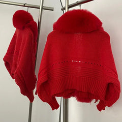 Side angle of the red faux fur and knit jacket showing the layered fur panel depth and sleeve volume on a clothing rack.